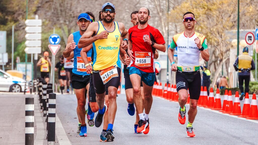 Dynamic scene of a group of male runners competing in an outdoor marathon.